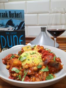 delicious tagine with Frank Herbert's Dune and a glass of wine