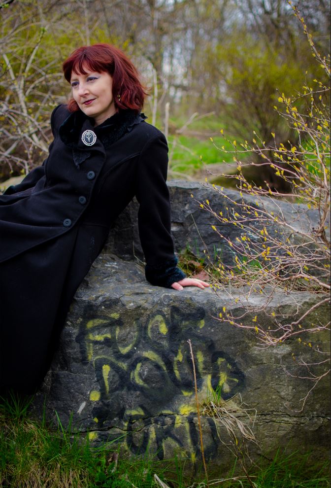 Rachel sitting on a rock which has extremely good taste in Premiers