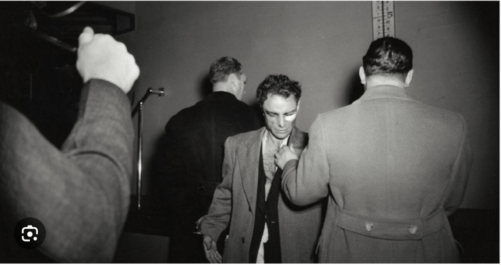 A picture of, well, a pic of Mad Dog Esposito with dishevelled sexiness, his moral anarchy, his casual, oversized trench coat, the torn shirt and ripped jacket revealing a manly chest with the right amount of chest hair.