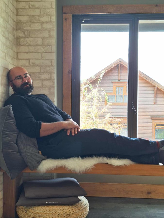A picture of Ben relaxing by a window